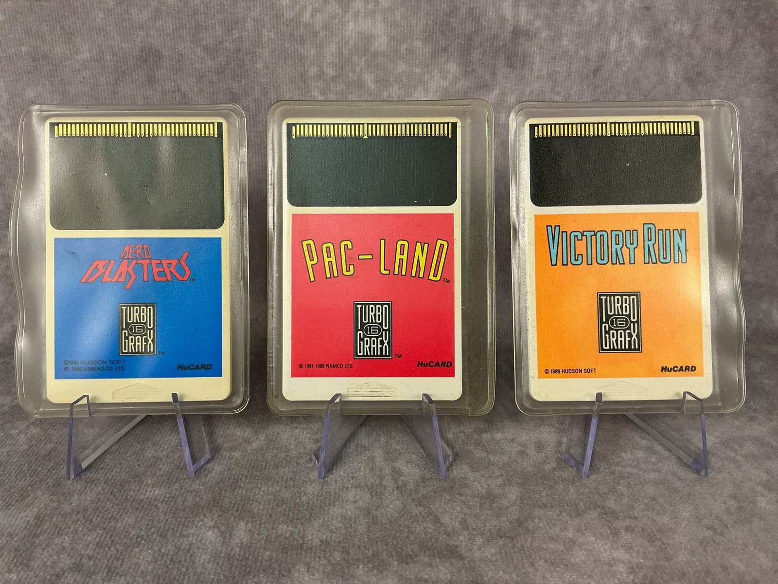 TurboGrafx-16 Games: Three games for the NEC TurboGrafix-16, made in Japan. Includes Aero Blasters, Victory Run, and PAC-Land in plastic sleeves. Games are untested, but in good condition. Each one measures 2 inches wide