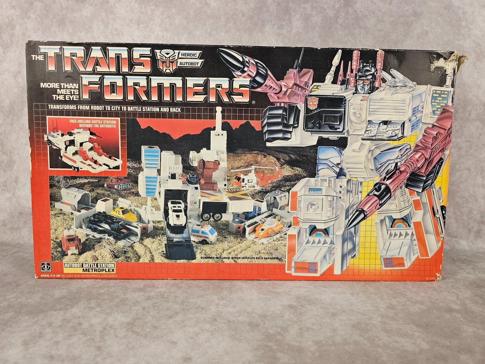Transformers Metroplex: 1985 Transformers Autobot Battle Station, Metroplex made by Hasbro in Japan. In original box, missing some pieces, box has heavy wear. Measures 18 inches wide x 5 x 10 inches tall.