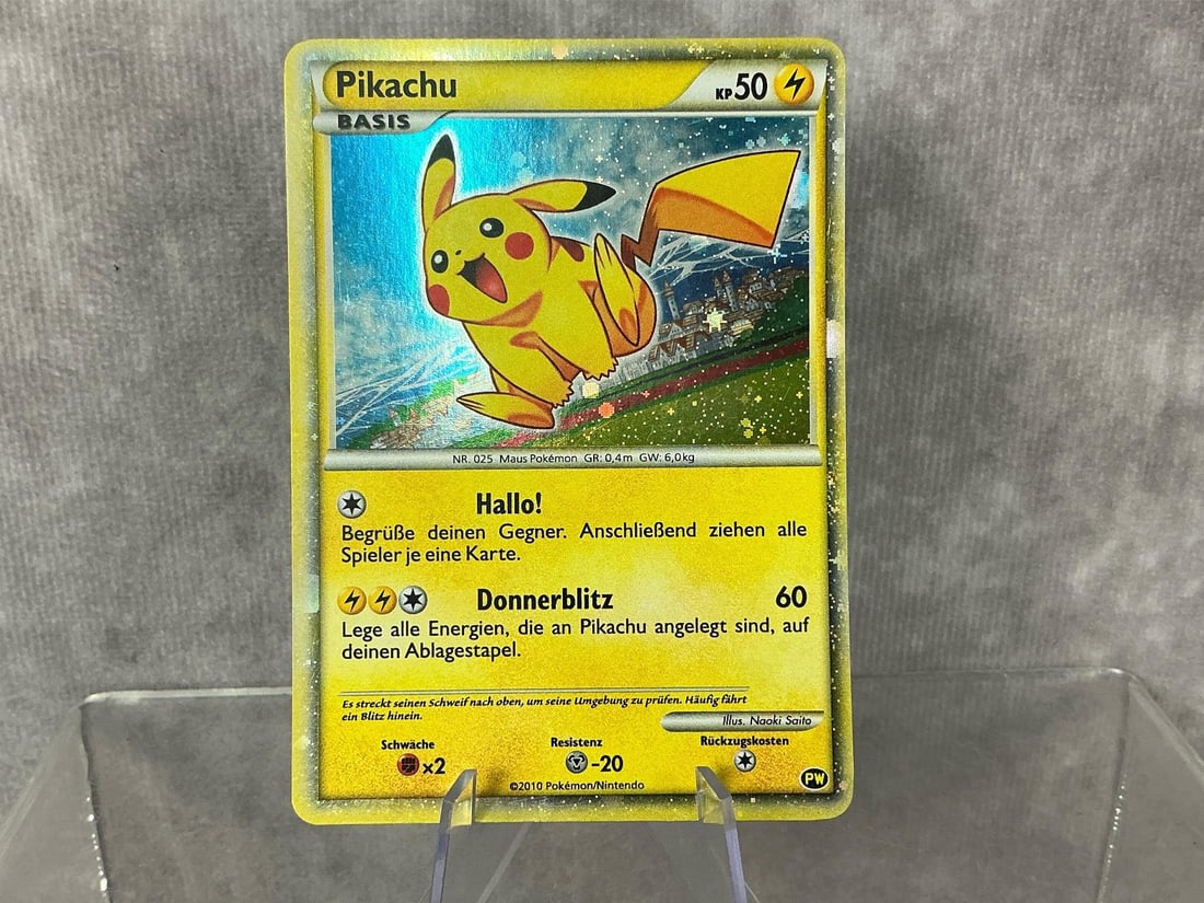 German Pikachu: 2010 Pikachu World Collection holographic card in German. Good condition. Measures roughly 2.75 inches wide x 3.5 inches tall.