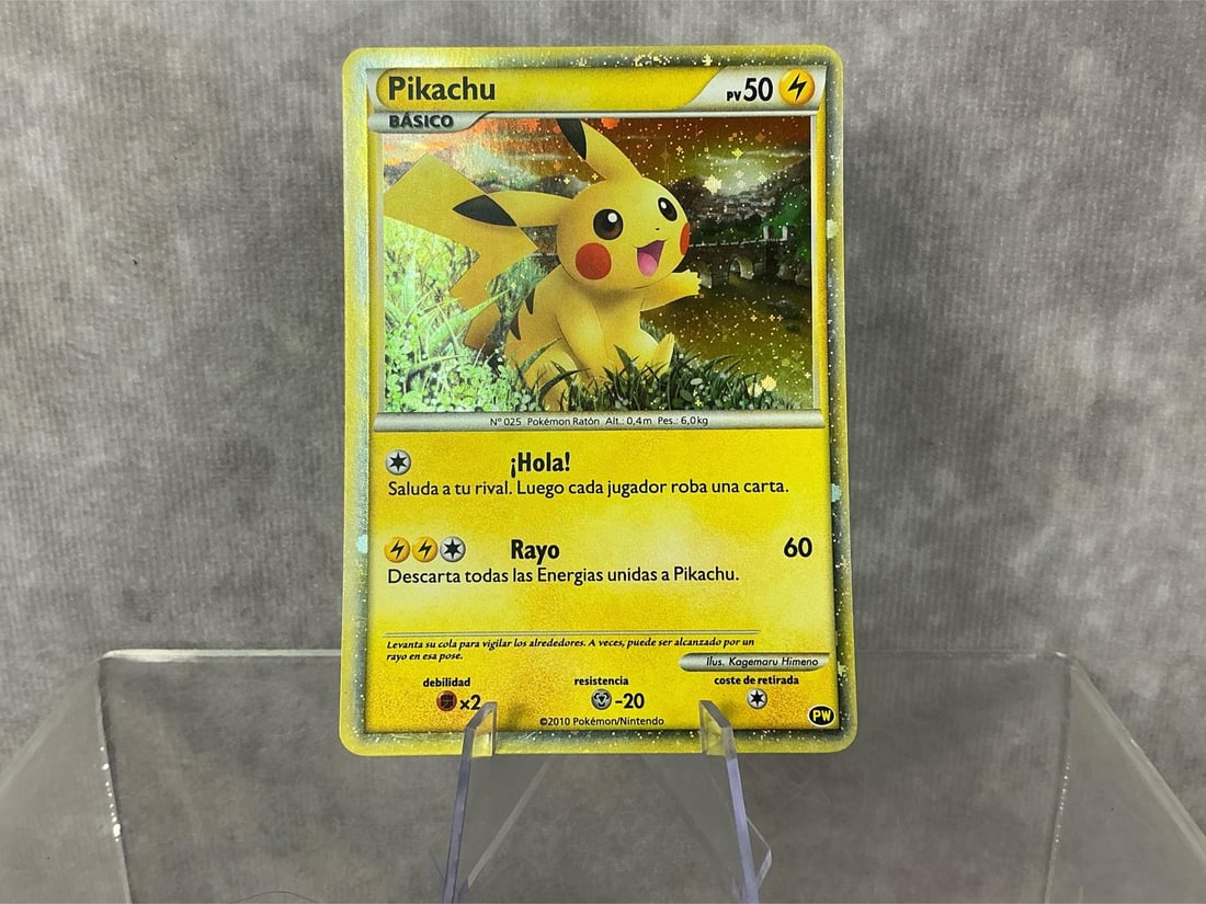 Spanish Pikachu: 2010 Pikachu World Collection holographic card in Spanish. Good condition, slight bowing. Measures roughly 2.75 inches wide x 3.5 inches tall.