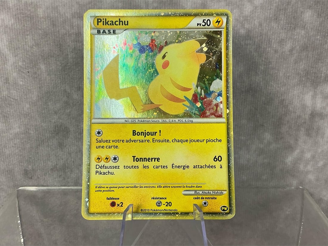French Pikachu: 2010 Pikachu World Collection holographic card in French. Good condition, slight bowing. Measures roughly 2.75 inches wide x 3.5 inches tall.
