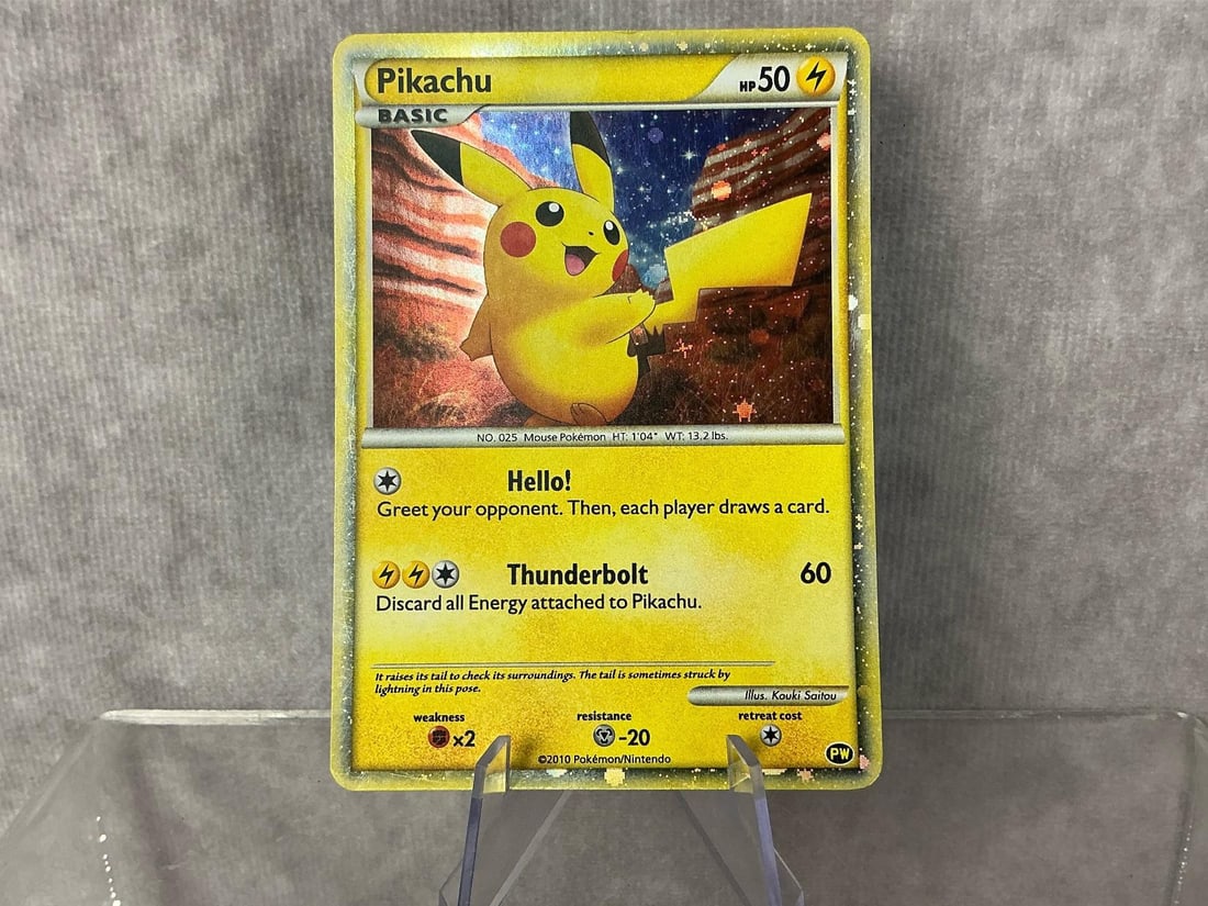 English Pikachu: 2010 Pikachu World Collection holographic card in English. Good condition, slight bowing. Measures roughly 2.75 inches wide x 3.5 inches tall.
