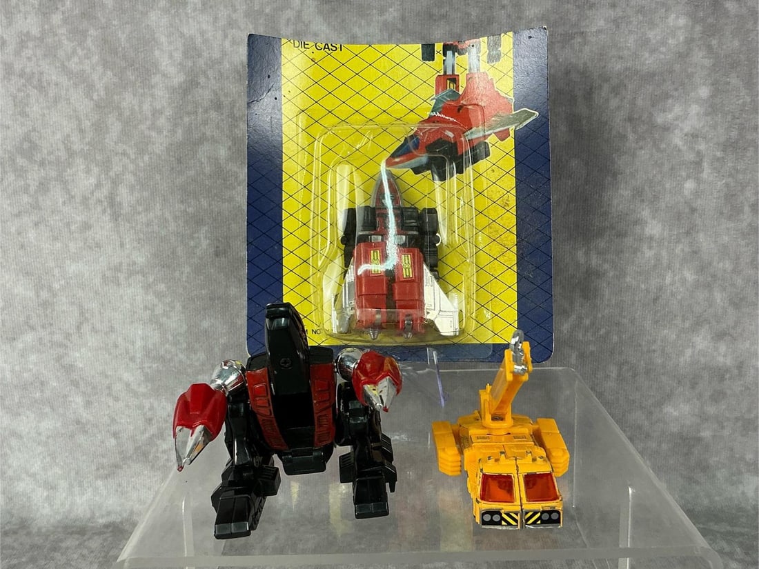 GoBots: Three 1980s GoBots made by Bandai in Korea and Japan. 1989s item No YJ-2 Plane sealed on cardboard backing is a “bootleg” version of a GoBot, made in Korea by an unknown company. 1983 Crain