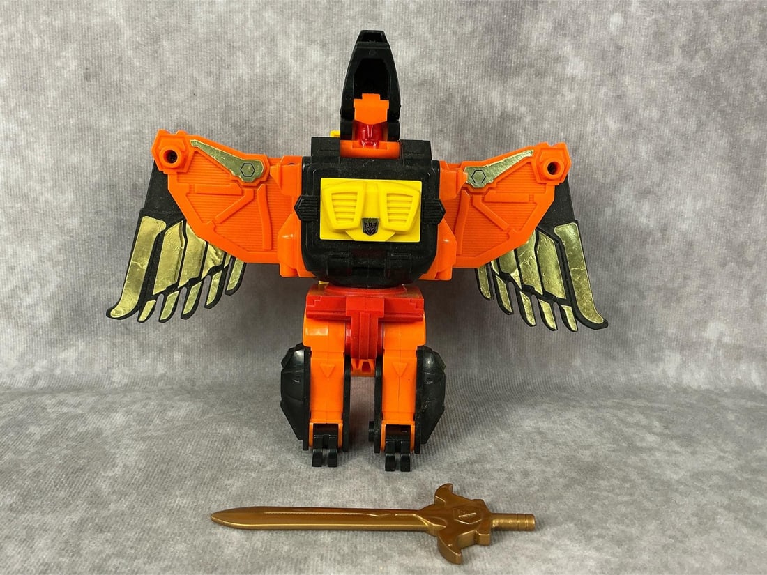 Divebomb Transformer: 1986 Predacon Divebomb Transformer generation one, made by Hasbro in Japan. Comes with original sword. General play wear and damage to decals. Measures 7.75 inches wide x 5.5 inches tall.