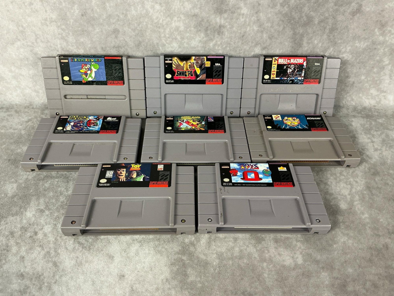 Super Nintendo Games: Eight vintage Super Nintendo games. Includes Shaw-Fu, Bulls vs Blazers, Super Mario World, Mario’s Time Machine, Toy Story, Toys, Animaniacs, and Mickey Mania. All untested and have general wear. Ea