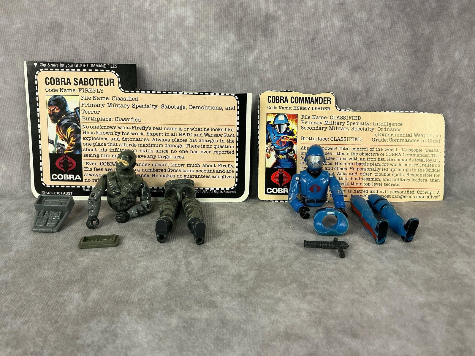 G.I. Joe Action Figures: 1983 and 1985 G.I. Joe action figures made by Hasbro in Hong Kong. 1983 Cobra Commander with file card and gun, broken waist piece and discoloration on one side of leg. 1984 Cobra Saboteur Firefly