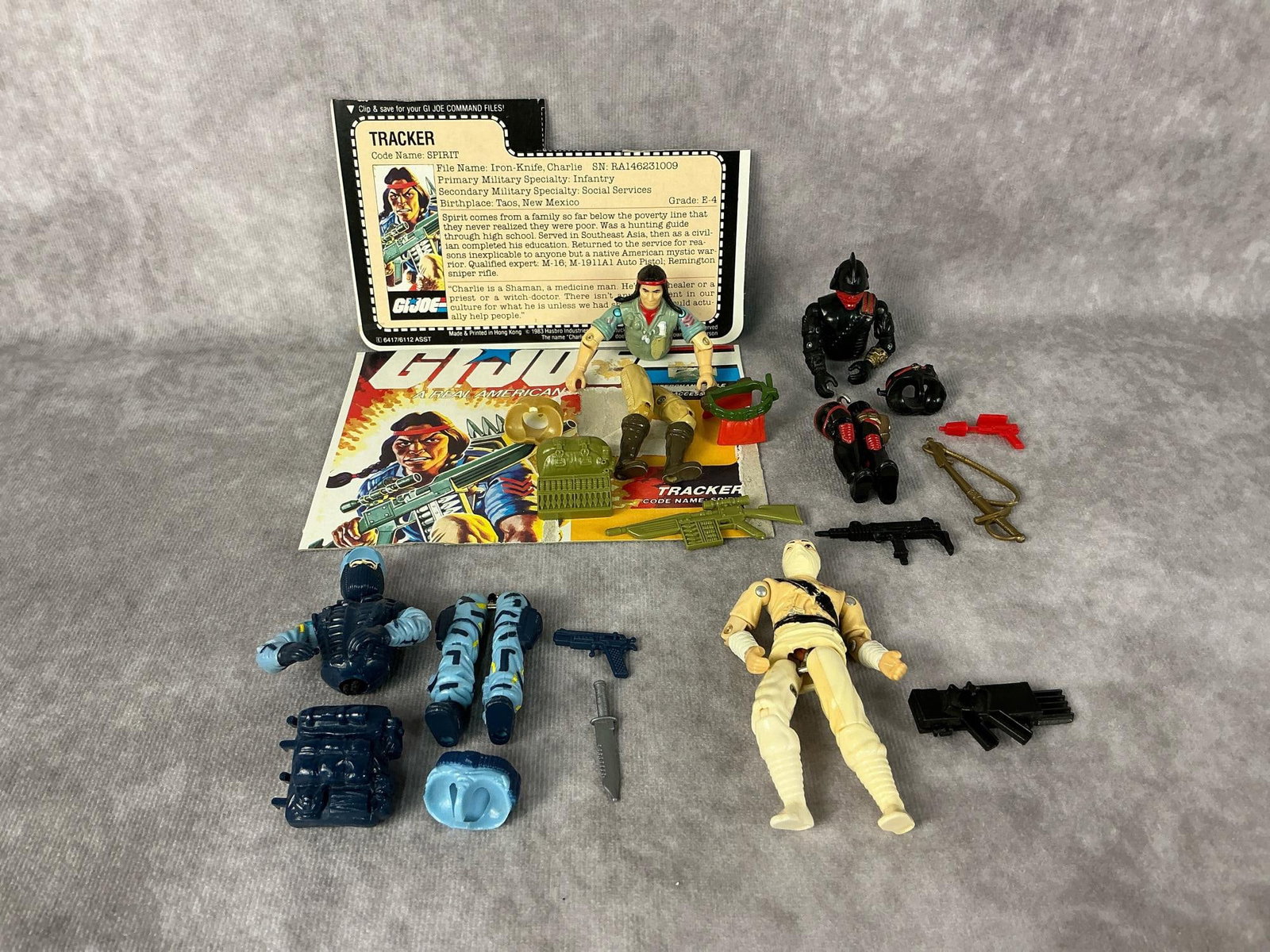G.I. Joe Action Figures: Four 1984 and 1988 G.I. Joe action figures made by Hasbro in Hong Kong. 1984 Spirit Tracker with file card, cardboard backing, pack, belt, and gun, broken waist piece. 1984 Cobra Storm Shadow with