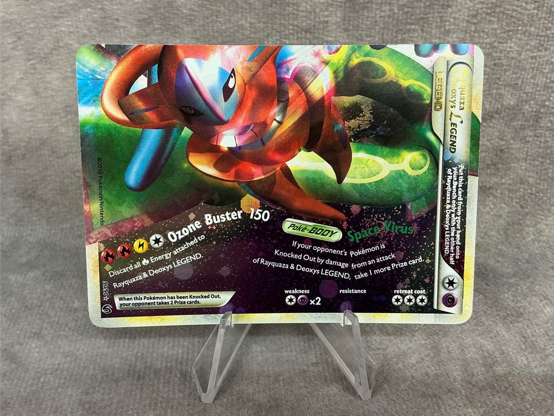 Rayquaza Pokemon Card: 2010 Pokemon Rayquaza & Deoxys legend holographic card, bottom only. Some bowing, otherwise good condition. Measures 2.5 inches wide x 3.5 inches tall.