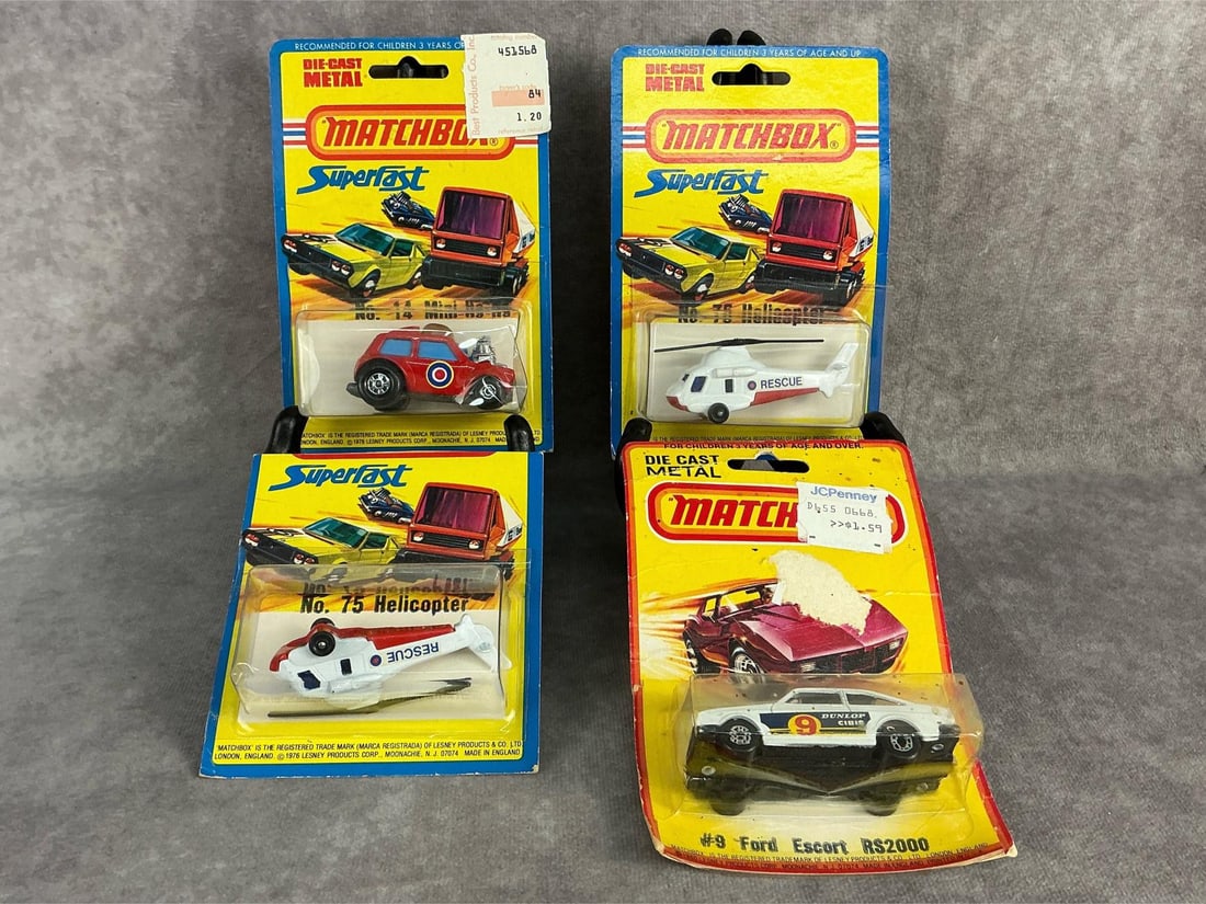 Vintage Matchbox Cars: Three 1976, and one 1980 Matchbox cars in original packaging. Made by Lesney in England. Includes No. 14 Mini-ha-ha, No. 9 Ford Escort RS2000, and two No. 75 Rescue Helicopter. Wear to all packaging,