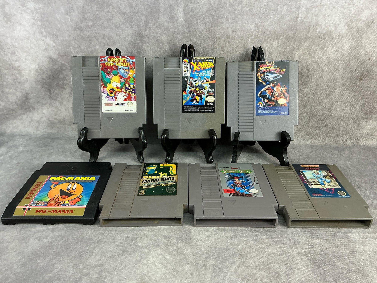 Nintendo Games: Seven vintage original Nintendo NES games. Includes PAC-Mania, Krusty’s Fun House, X-Men, Back to the Future II & III, Simon’s Quest, Gun Smoke, and Super Mario Brothers. All are untested and
