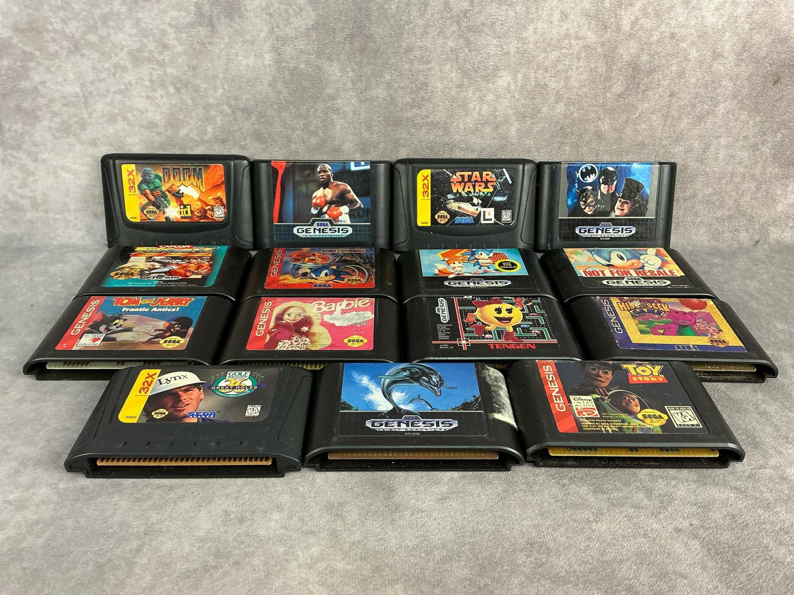 Sega Genesis Games: Fifteen vintage original Sega Genesis games made in Japan and Taiwan. Includes Sonic, Batman Returns, Doom, Street Fighter II, Star Wars, and more. All untested and have wear. Each one measures 4.25