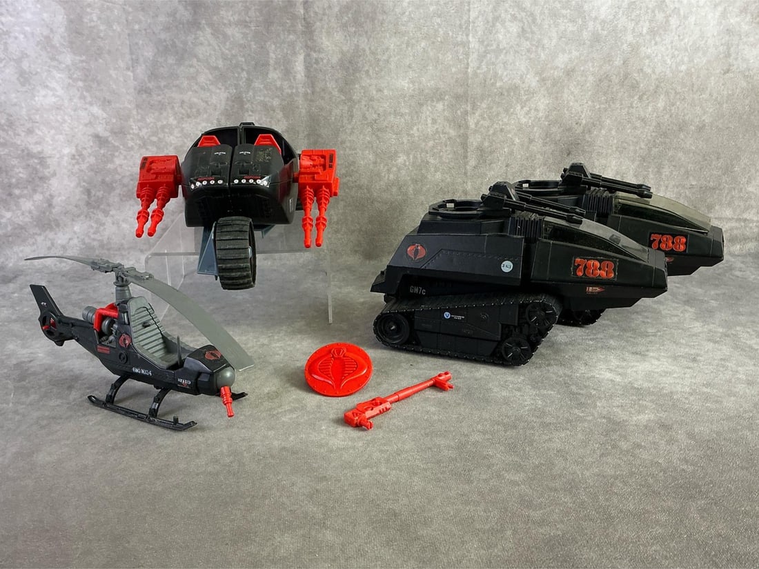 GI Joe Vehicles: Four GI Joe vehicles including 1986 Cobra Stun, two 1983 Cobra H.I.S.S. Tanks, and 1983 F.A.N.G helicopter. All in fair used condition with damage and missing parts to each. Cobra Stun measures 12 inc