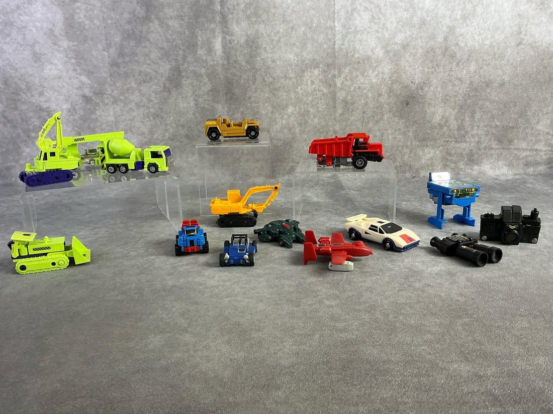 Transformers: Fifteen 1980s Transformers toys. All in fair to good condition. Pinball Transformer measures 2.5 inches wide x 2.5 inches tall.