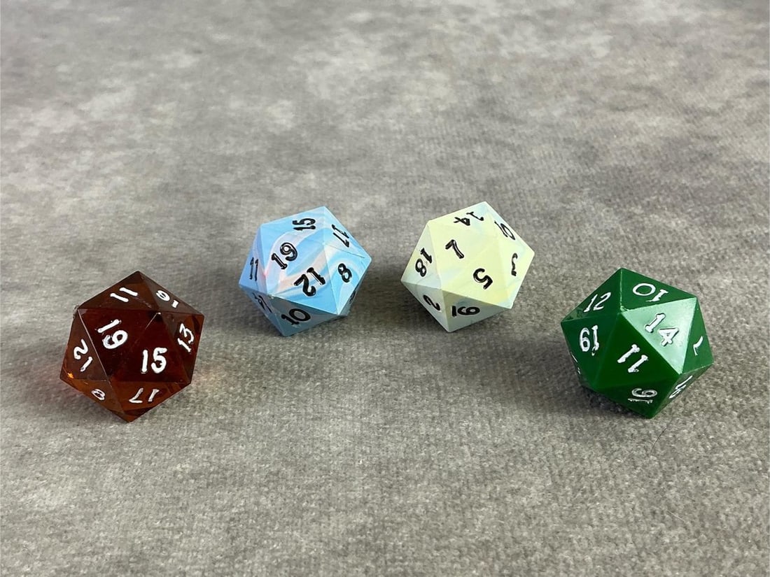 D20 Dice: Four vintage D20 dice in a variety of colors. Each are 20 sided die and frequently used for role play games. Each approximately measure 0.6 inches.
