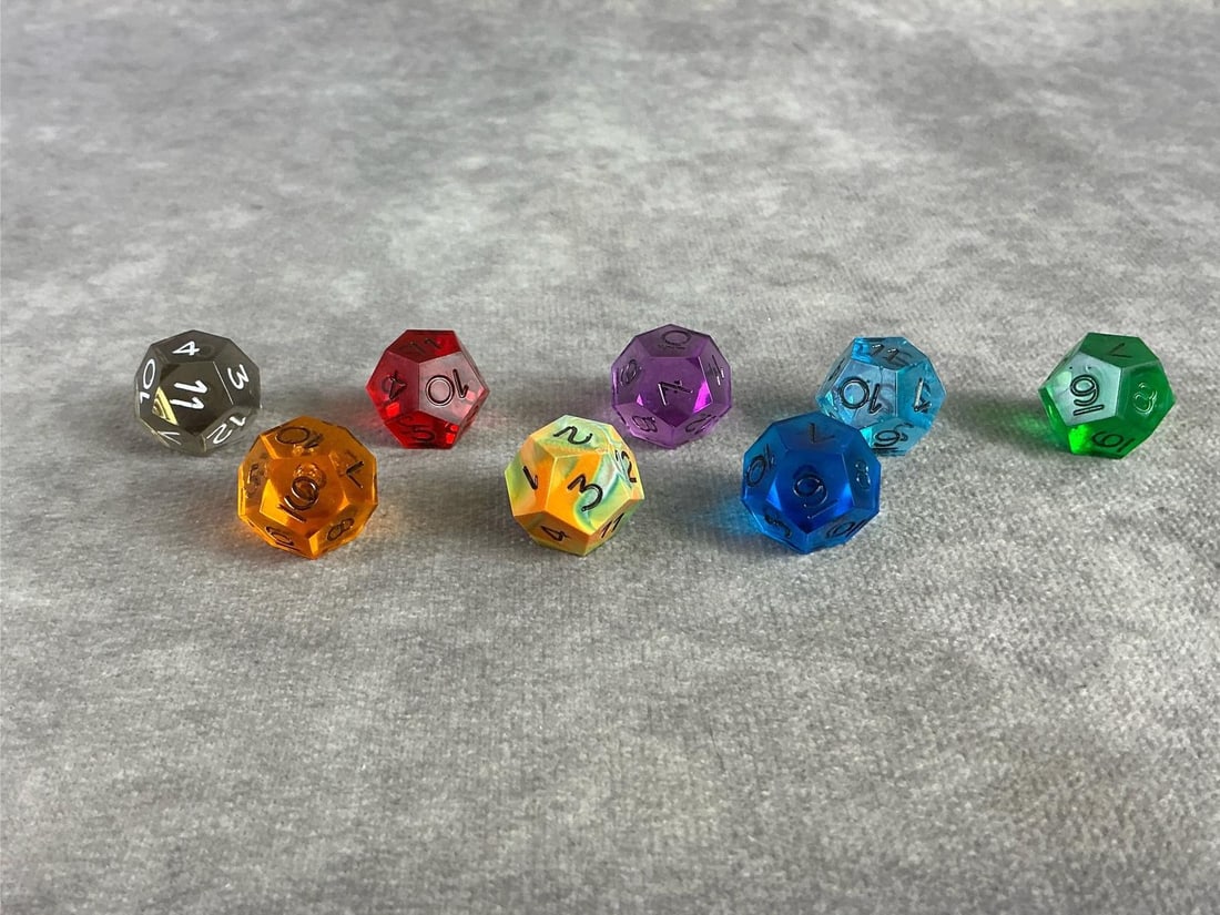 D12 Dice: Eight vintage D12 dice in a variety of colors. Each are twelve sided die and commonly used for role play games. Each approximately measure 0.6 inches.