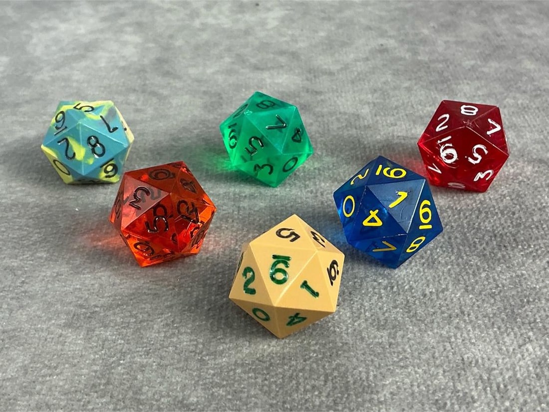 D20 Dice: Six 1970s 20 sided die with numbers on it twice 0 to 9. Used in early role play and in good condition with a variety of colors. Each measures approximately 0.75 inches.