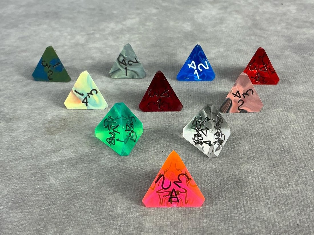 Tetrahedron Dice: Ten vintage tetrahedron die, four sided with three numbers on each side. In good condition and commonly used for role play games. Each measures approximately 0.75 inches.