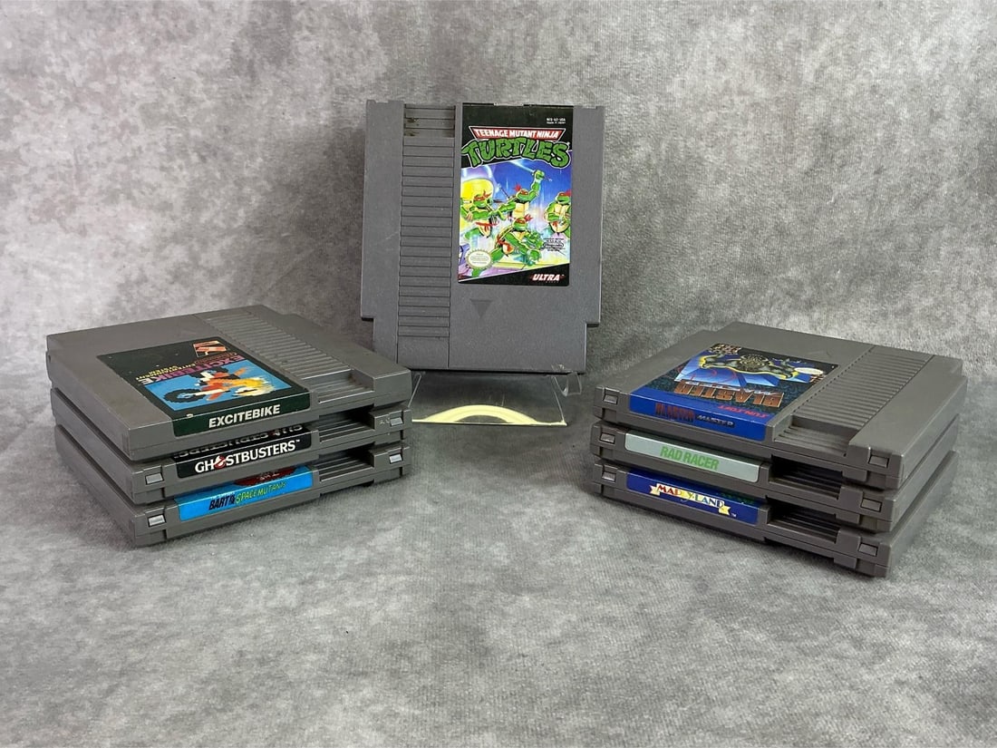 NES Games: Seven Nintendo Entertainment System Games including TMNT, Ghostbusters, Rad Racer, and more. All in good untested condition. Each measures 4.65 inches wide x 5.25 inches tall.