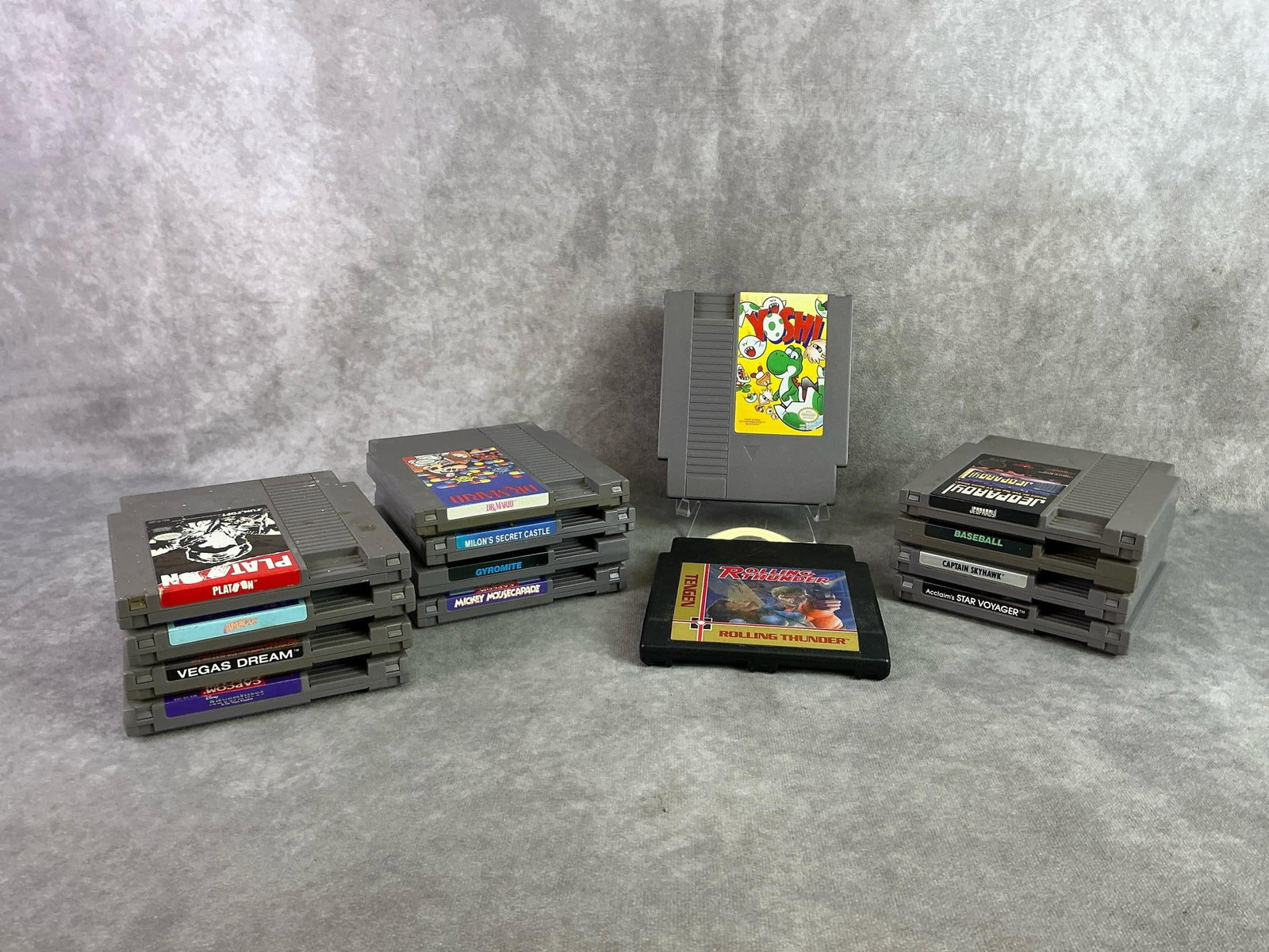 NES Games: Fourteen Nintendo Entertainment System Games including Yoshi, Platoon, Dr. Mario, and more. All in good untested condition. Each measures 4.65 inches wide x 5.25 inches tall.