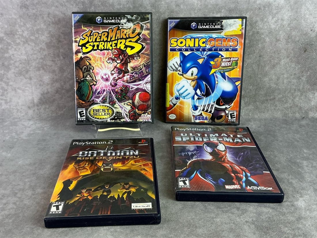 Gamecube & Playstation 2 Games: Two Nintendo GameCube games and two PlayStation 2 games including Super Mario Strikers, Sonic Gems, Batman, and Spider-Man. All in good untested condition. Each measures 5.25 inches wide x 7.4 inches