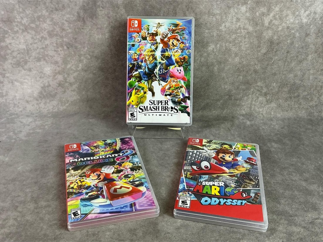 Nintendo Switch Games: Three Nintendo Switch games including Super Smash Bros, Mario Odyssey, and MarioKart. All in good untested condition. Each measures 4 inches wide x 6.5 inches tall.