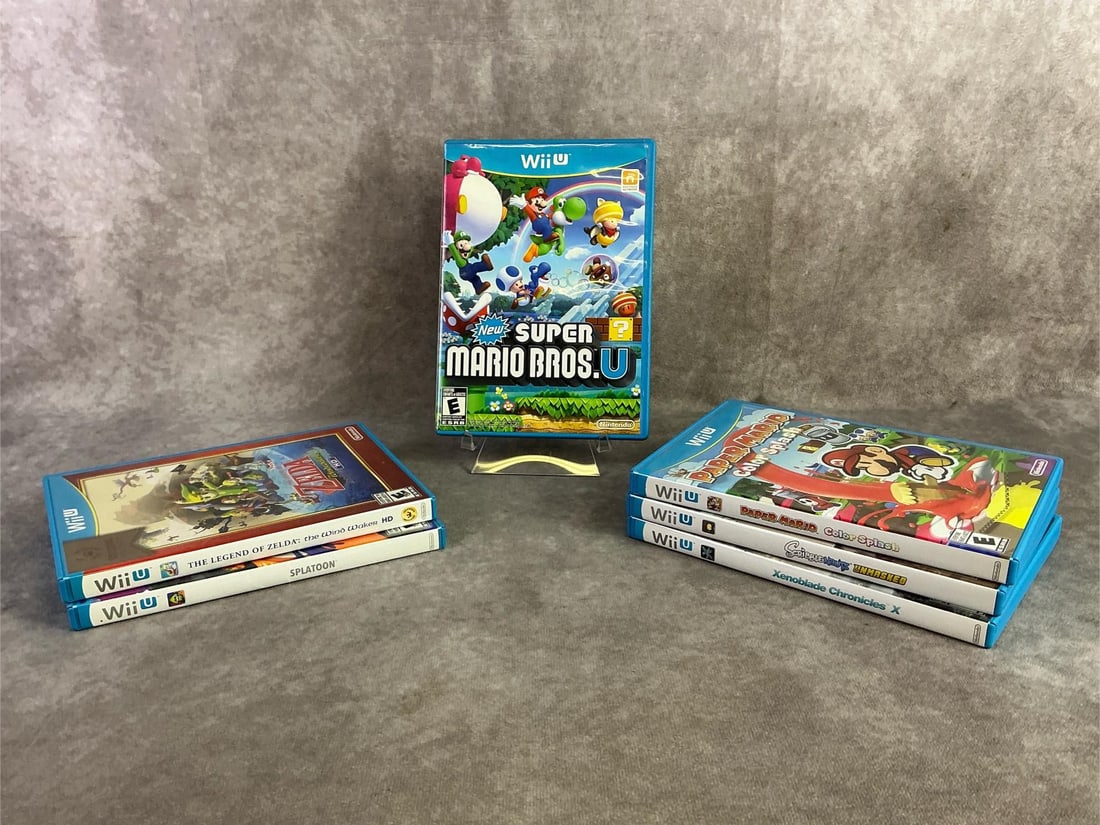 Wii U Games: Six Wii U games including Super Mario Bros., Zelda, Splatoon, and more. All in good untested condition. Each measures 5.25 inches wide x 7.5 inches tall.