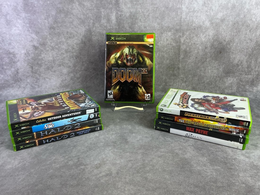 XBox Games: Nine vintage original Xbox games including Doom 3, The Sims, Halo 2, and more. All in good untested condition. Each measures 5.25 inches wide x 7.5 inches tall.