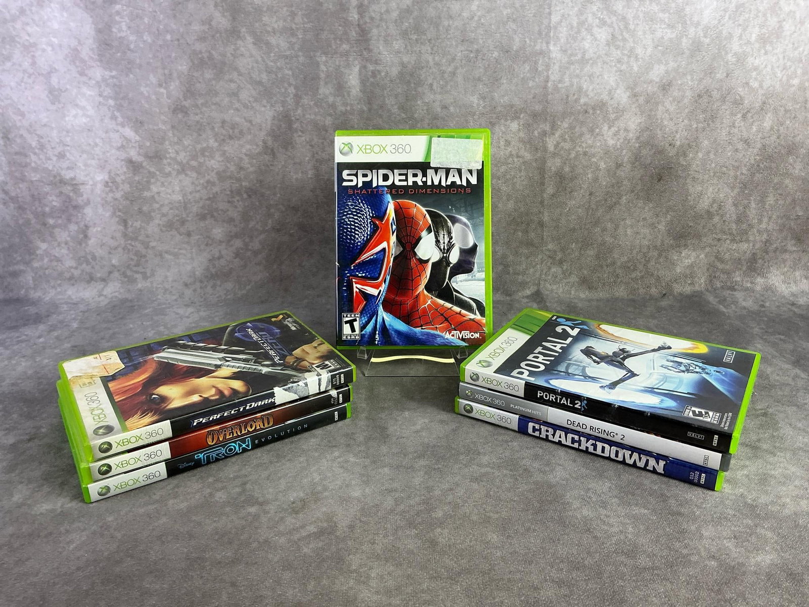 Xbox 360 Games: Seven Xbox 360 games including Spiderman, Overload, Portal 2, and more. All in good untested condition. Each measures 5.25 inches wide x 7.5 inches tall.