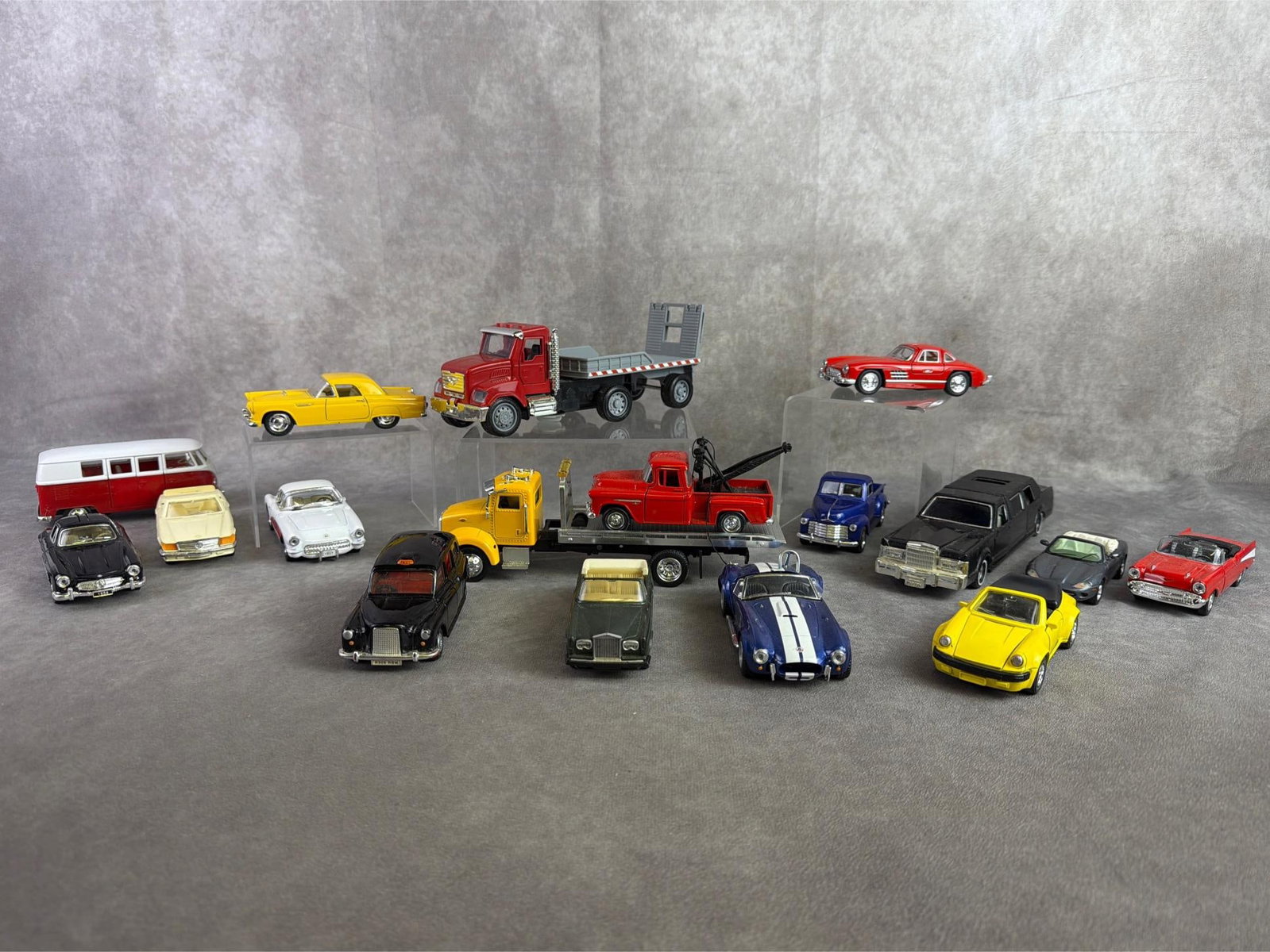 Model & Toy Cars: Seventeen model and toy cars including rollbacks, classic, transportation, and more. All in good condition with several being pull back vehicles. Largest measures 3 inches wide x 9 inches tall.