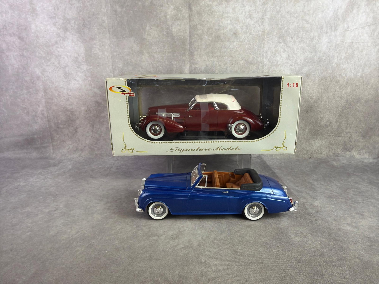 Model Cars: Two model cars including Model of 1937 Cord 812 made by Signature, still in original box and Solido model of 1961 Rolls Royce Sylvercloud II. Both in good condition. Box measures 14 inches wide x 6