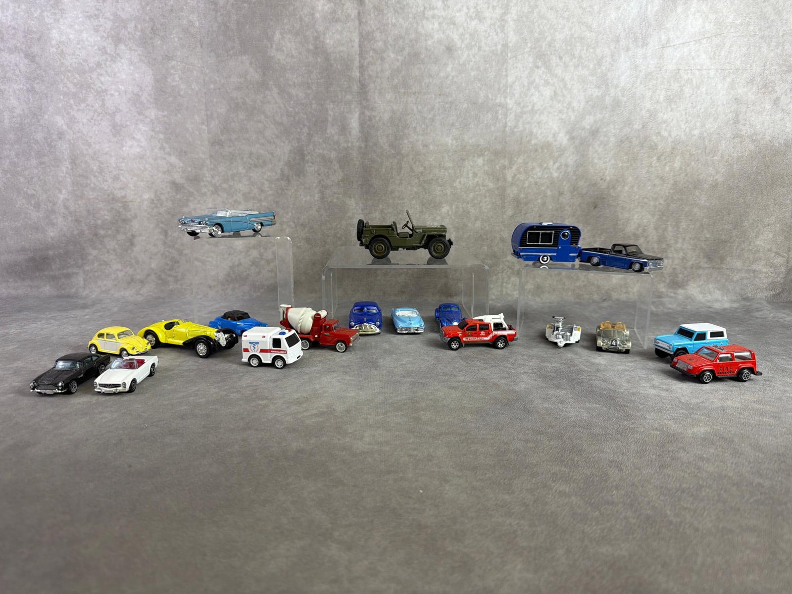 Toy Cars: Eighteen toy cars in a variety of make and models, branded from Matchbox, Maisto, and Hotwheels. All in good condition. Largest measures 1.75 inches wide x 4.5 inches tall.