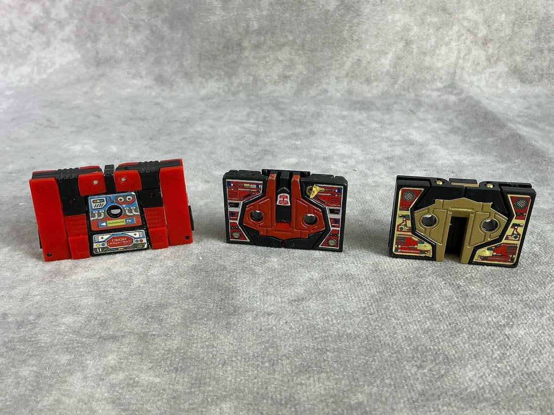 Hasbro Transformers: Three 1984 Hasbro Generation one Transformer cassette toys. All in good condition. Each measures 2.5 inches wide x 1.5 inches tall.