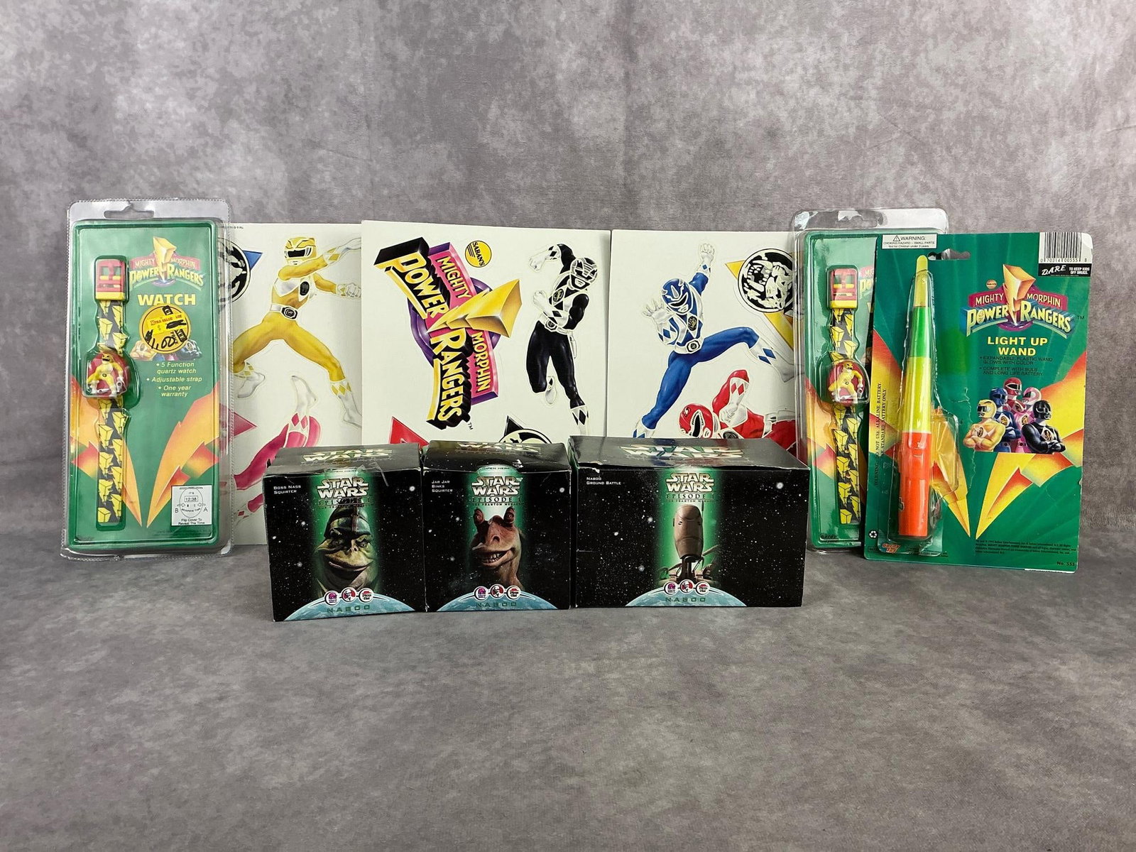 Power Rangers & Star Wars: Seven 1990s Power Rangers and Star Wars toys. Includes two 1993 watches, 1993 light up wand, glow in the dark decals, and three Taco Bell Star Wars figures. All sealed in original packaging except Pow