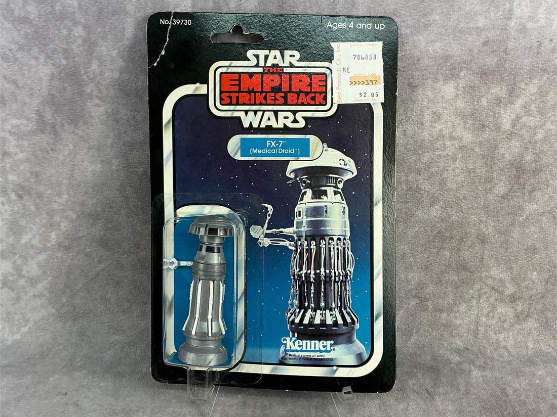 FX 7 Medical Droid: 1977 Star Wars The Empire Strikes Back FX 7 Medical Droid made by Kenner, still in original box with corner torn and warping to box. Box measures 6 inches wide x 9 inches tall.