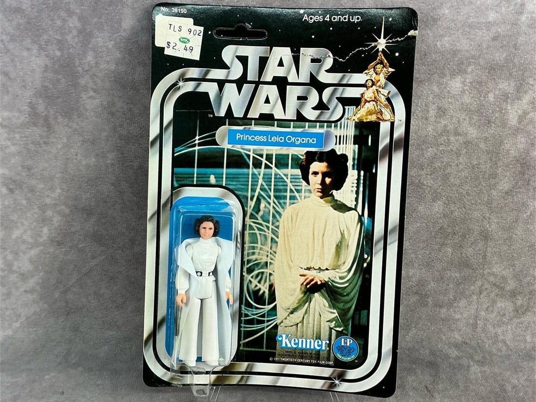 Princess Leia Organa: 1977 Star Wars Princess Leia Organa made by Kenner, still in original box with corner torn and warping to box, yet unpunched. Box measures 6 inches wide x 9 inches tall.