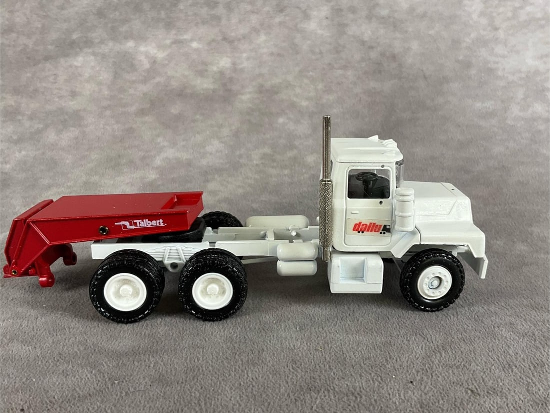 Conrad MACK 1:50 Die-cast Tractor & Trailer: Group of two, duplicate Mack truck diecasts. Both are in good condition, with original parts and boxes. No visible play-wear. Very good condition. Each measures 15 inches long x 2 inches wide x 3