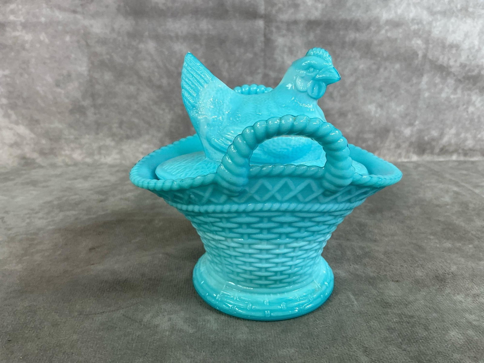 Hen on Basket: Vintage Westmoreland hen on a basket dish. Aqua swirled glass with Westmoreland stamp on bottom. In good condition. Measures 5.5 inches wide x 4.25 x 5.25 inches tall.