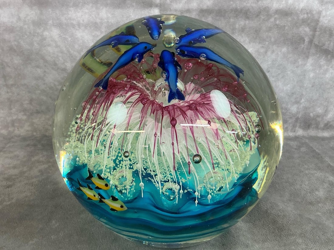 Large Murano Glass Paperweight: Vintage large hand made Murano, Italy Art glass paperweight, with original sticker. Ocean scene includes blue dolphins and fish with pink coral bloom in middle. In good condition. Measures 7 inches in