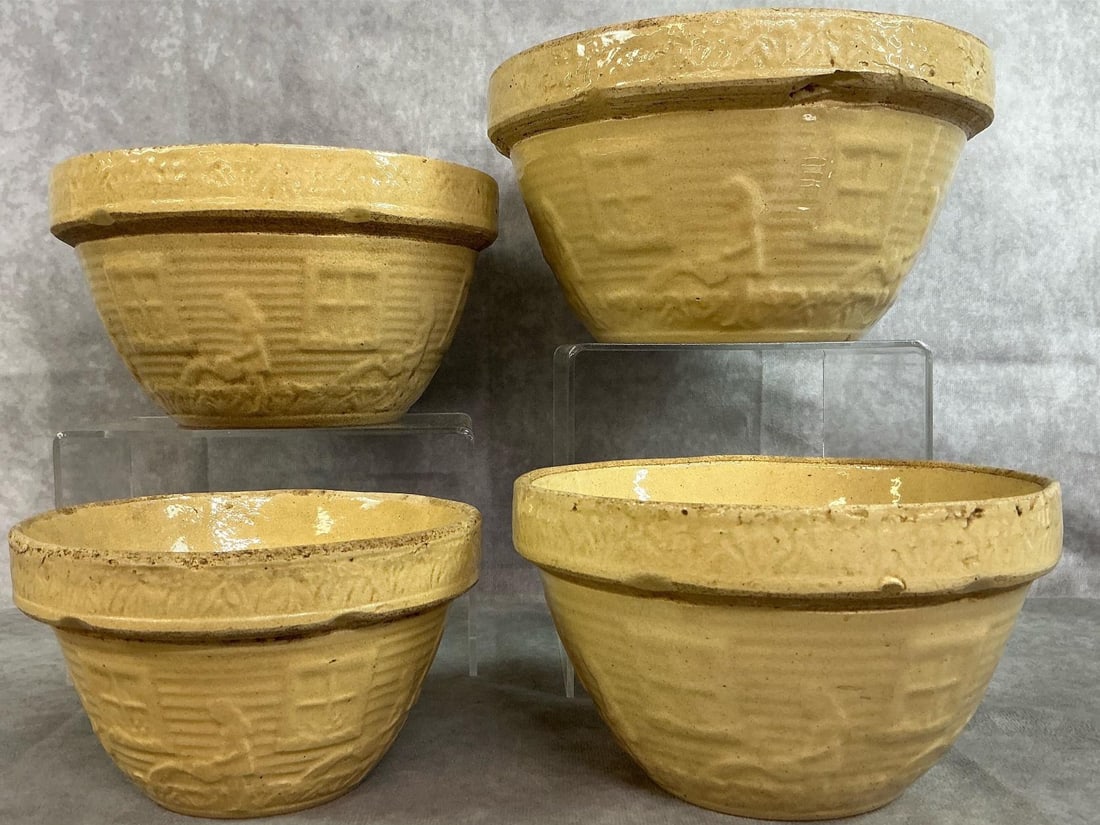 Yellow Ware Nesting Mixing Bowls: Four 1920's nesting mixing bowls."Girl with Watering Can" pattern by McCoy Pottery or Robinson-Ransbottom Pottery. Wear and crazing from age, otherwise in good condition. Largest bowl measures 9 inche