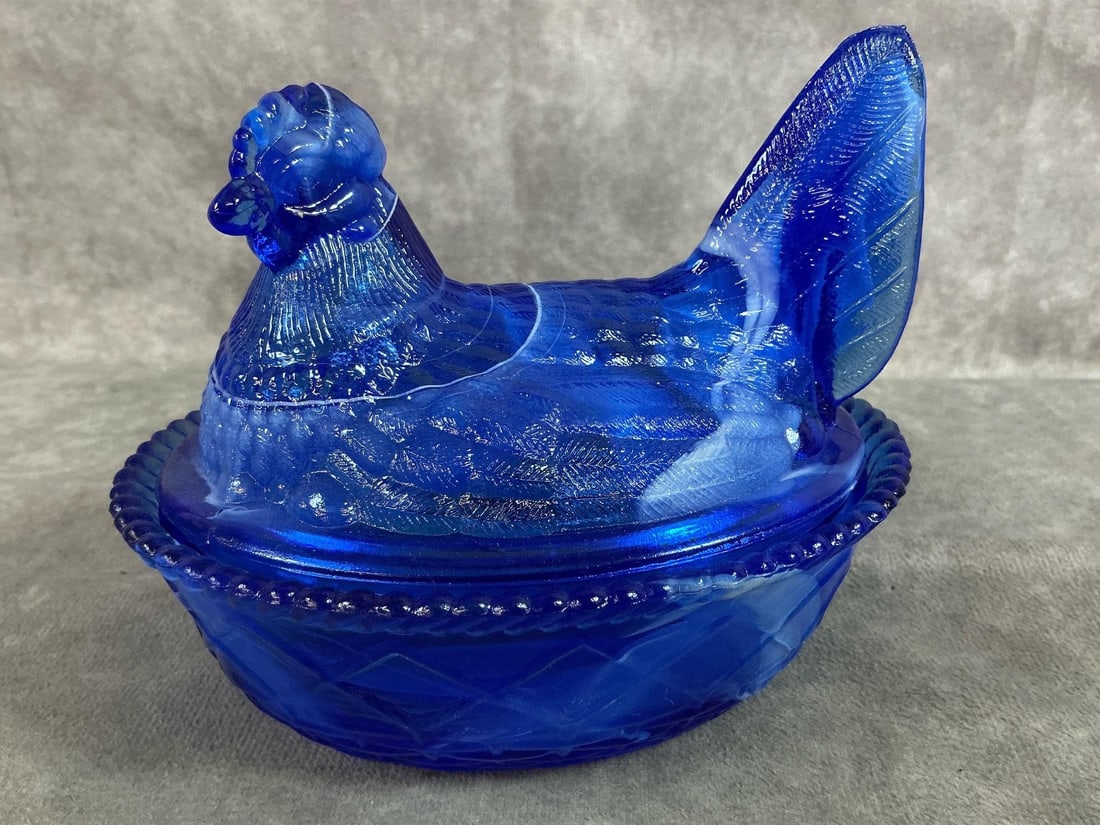 Cobalt & White Slag Hen on Nest: Mid 1900's Westmoreland hen on nest dish. Cobalt blue with white slag glass swirl. Westmoreland mark on bottom. In good condition. Measures 5.5 inches long x 4.25 x 4.5 inches tall.