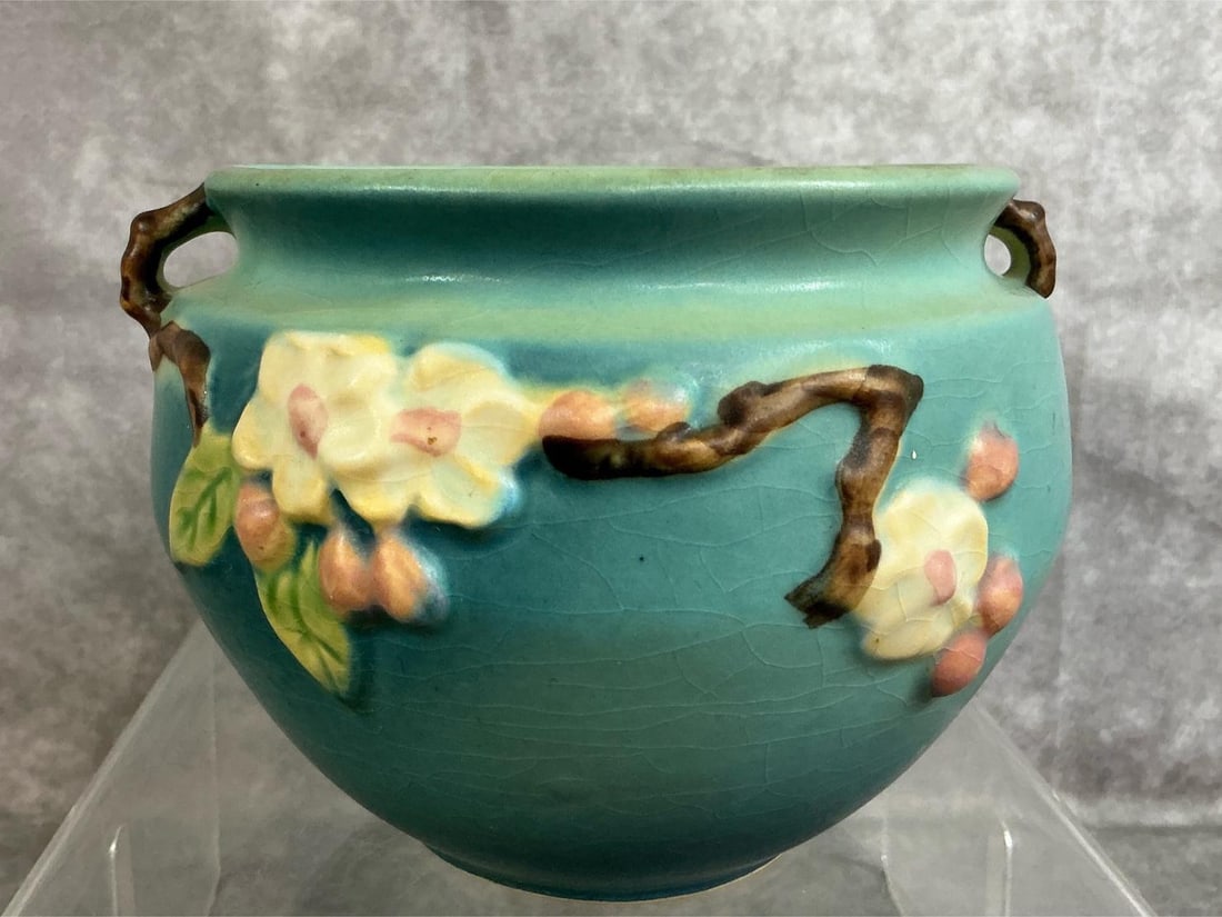 Roseville Apple Blossom Pottery: 1940's Roseville pottery. Apple Blossom with twig handles #30. Some crazing, otherwise in good condition. Measures 6 inches in diameter x 4.25 inches tall.