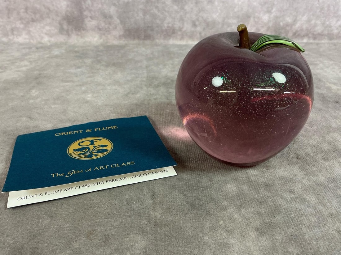Orient & Flume Apple: Vintage Orient and Flume Art glass apple paperweight. Purple with gold inclusions and green leaf detail. Marked "Orient and Flume" S0007P7 on bottom. Measures 3 inches in diameter x 3 inches tall.