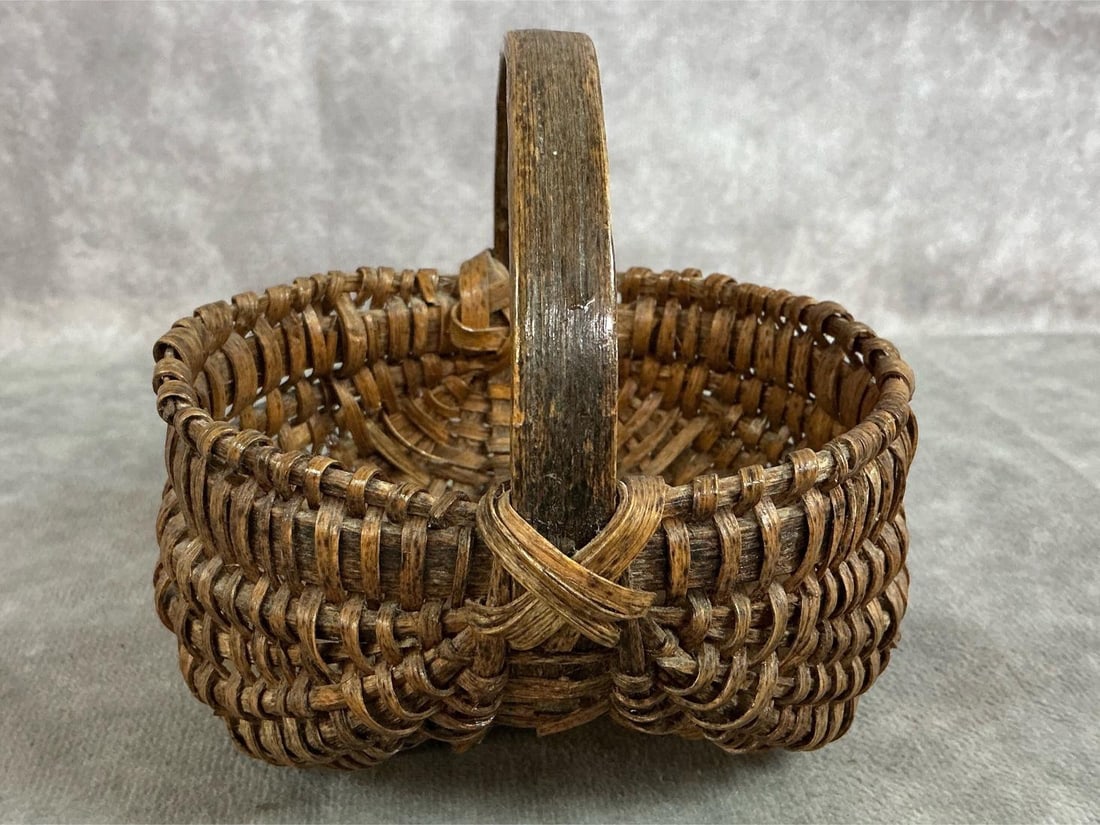 Miniature Basket: Antique Primitive buttocks basket. Handwoven mini basket. In good condition. Measures 4.25 inches wide x 4 x 4.25 inches tall.