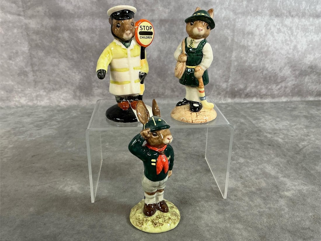 Bunnykins Collectible Figures: 1986-1987 Bunnykin figures by Royal Doulton. Includes "Lollipop Man" DB65, "School Days" DB57, and "Be Prepared " DB56. In good condition. Scout bunny measures 1.75 inches wide x 4 inches tall.
