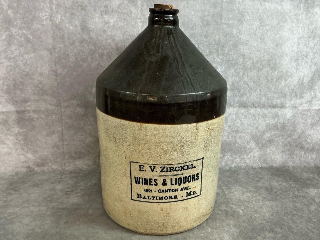 Baltimore Advertising Jug: Late 19th century brown and white two tone stamped advertising jug for " E.V. ZIRCKEL. / WINES AND LIQUORS/ 1821 - CANTON AVE., / Baltimore, . MD." Small chip to lip and small hole to base. Measures