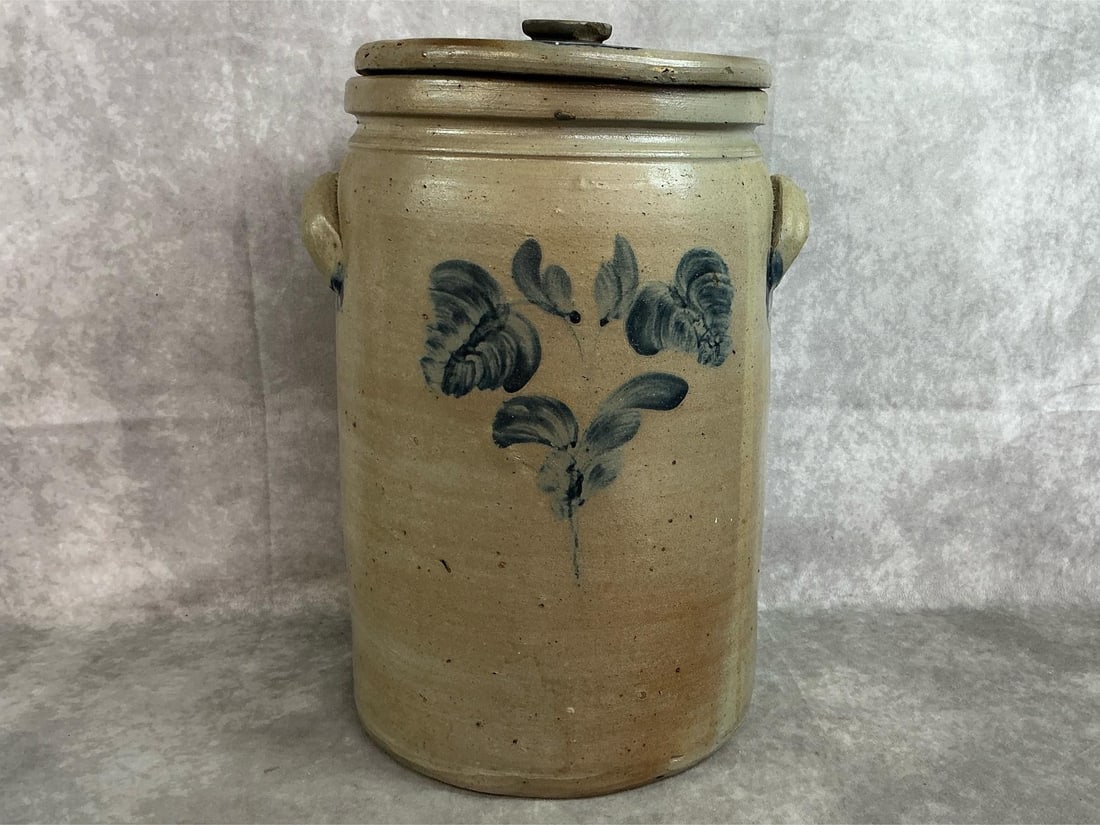 Stoneware Decorated Crock: Circa 1870 floral cobalt decorated stoneware lidded crock with decorated lug handles, tooled shoulder and squared rim, probably Baltimore, Maryland. Small chips to lid, otherwise good condition. Measu