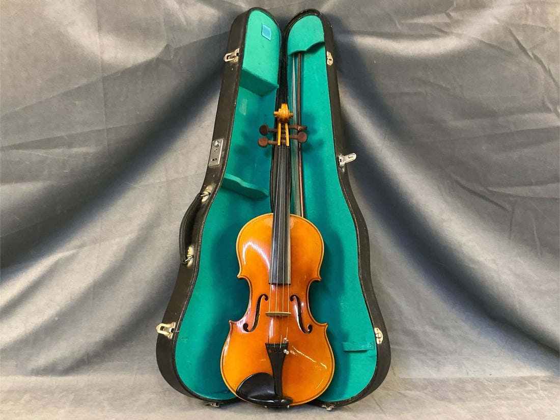 Violin: Late 20th century violin with bow and case. "Lark / Shanghai, China" paper label inside violin. Good condition. Case measures 31.5 inches wide x 9.5 x 4.25 inches tall.