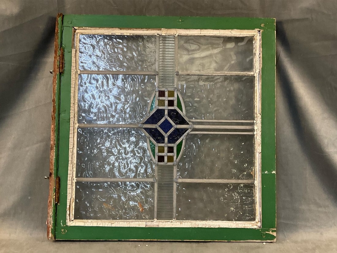 Antique Stained Glass Window: Early 20th century stained glass window. Window frame with peeling paint, otherwise good condition. Measures 23 inches wide x 2 x 23.75 inches tall.
