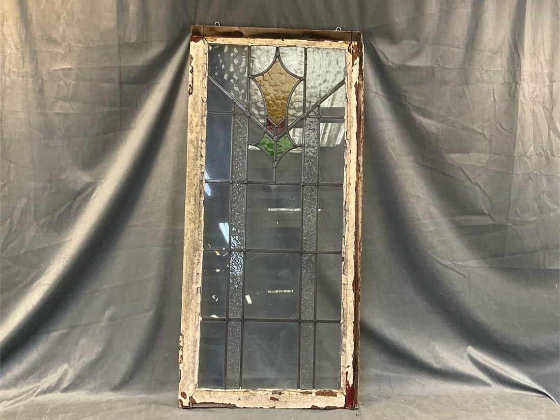 Antique Stained Glass Window: Early 20th century stained glass window. Window frame with peeling paint, otherwise good condition. Measures 20.5 inches wide x 2 x 44 inches tall.