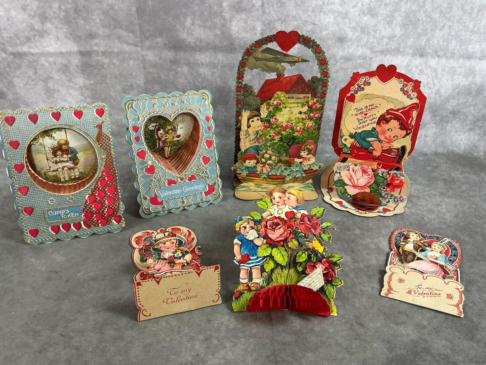 Stand Alone Valentines: Seven 1920's - 1930's valentines. Stand alone 3D, some with "honeycomb". Some mild color fade, otherwise in good condition. Largest measures 4 inches wide x 2 x 8 inches tall.